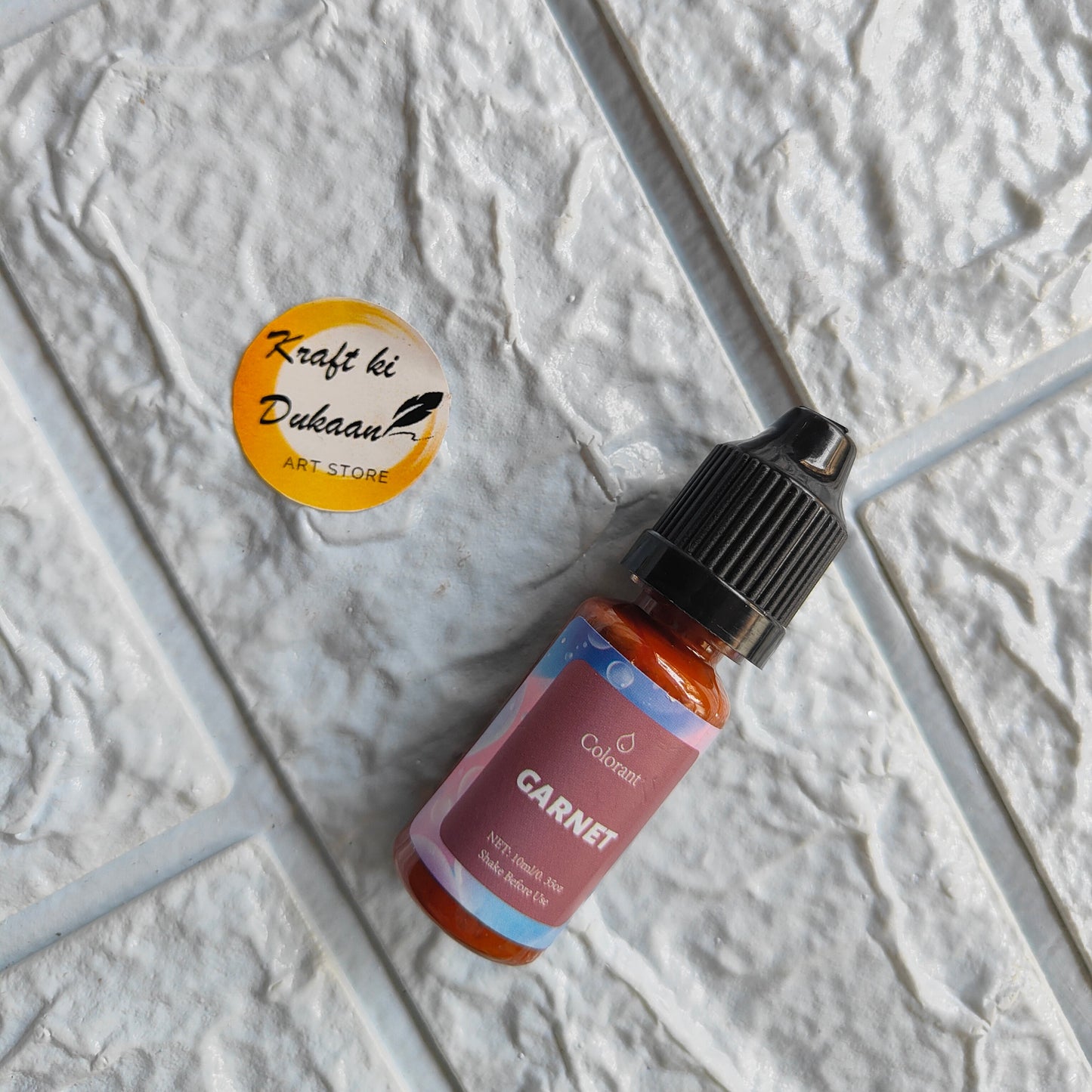Garnet resin pigment colorant bottle by Kraft ki Dukaan on textured background