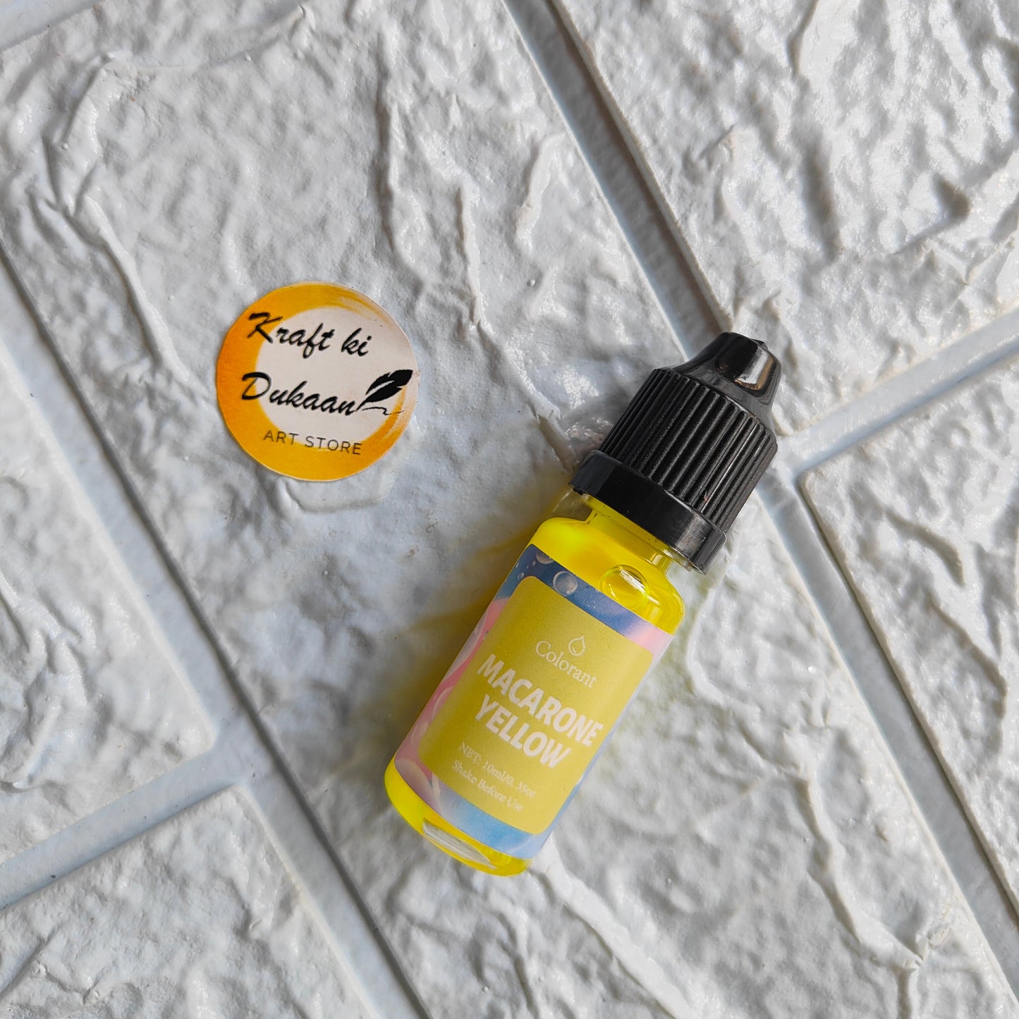 Kraft ki Dukaan Macarone Yellow Resin Pigment Colorant in a small bottle for vibrant artistry