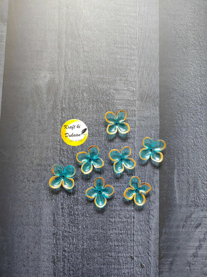 Flower-shaped bead charms with turquoise and yellow accents, assorted colors