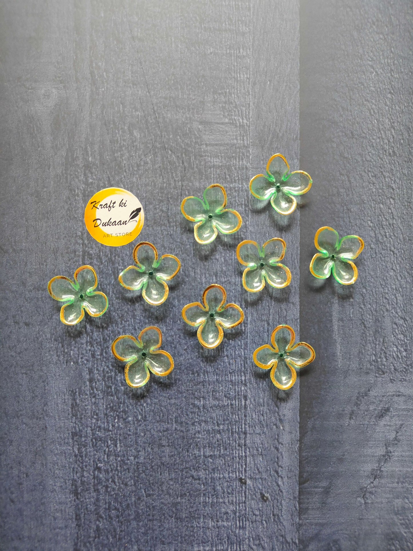 Green flower beads with yellow edging, scattered on surface