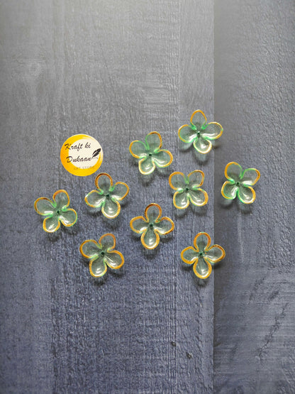 Green flower beads with yellow edging, scattered on surface
