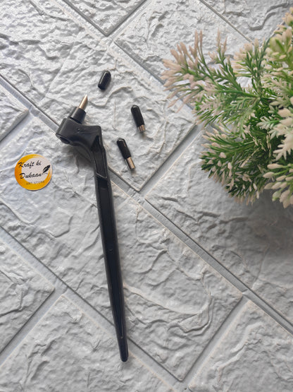 Black 360-degree rotating cutting tool with interchangeable tips on textured gray surface near green plant