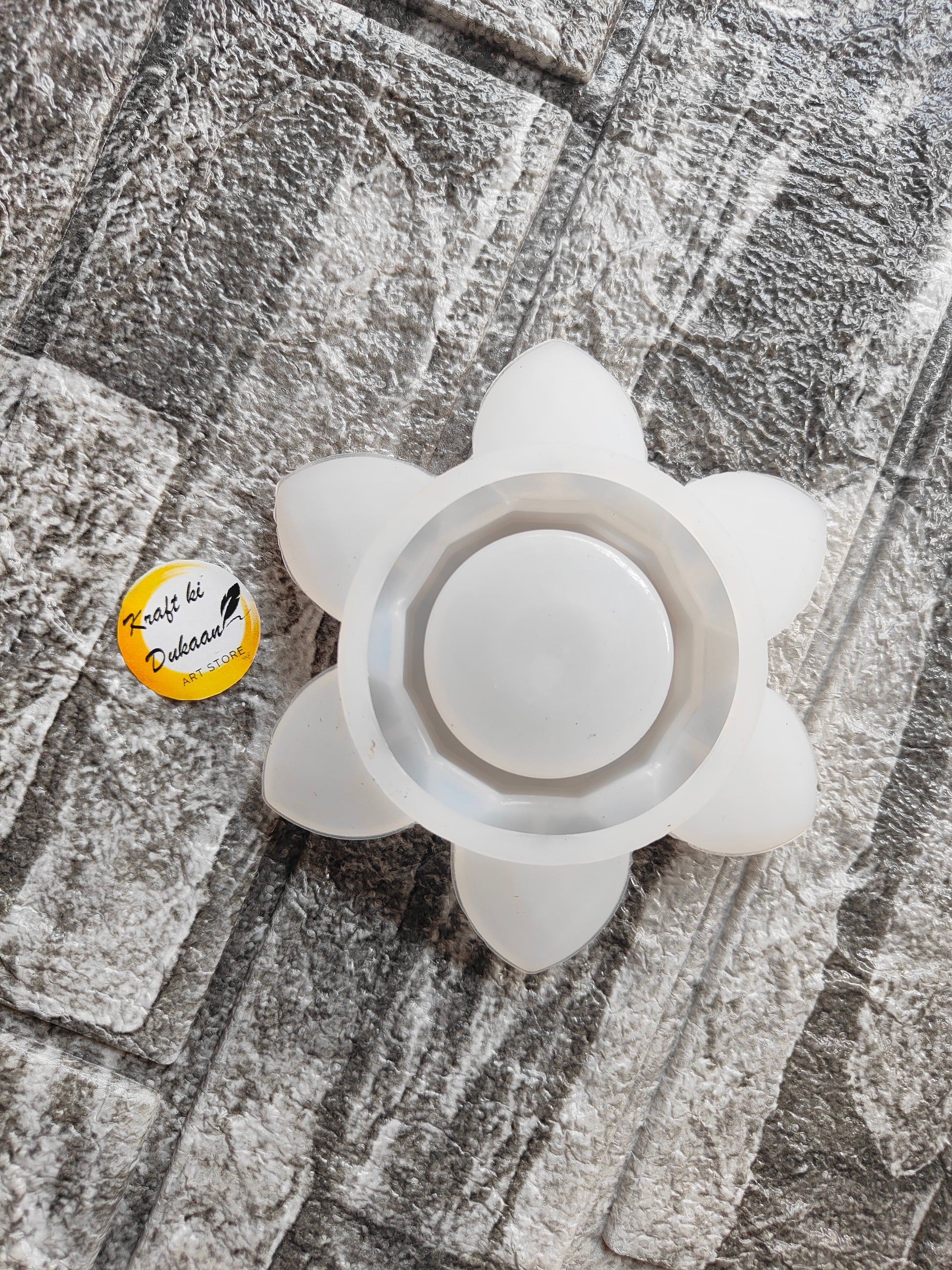 Lotus T-Light Holder Mold by Kraft ki Dukaan white flower-shaped silicone mold on textured surface