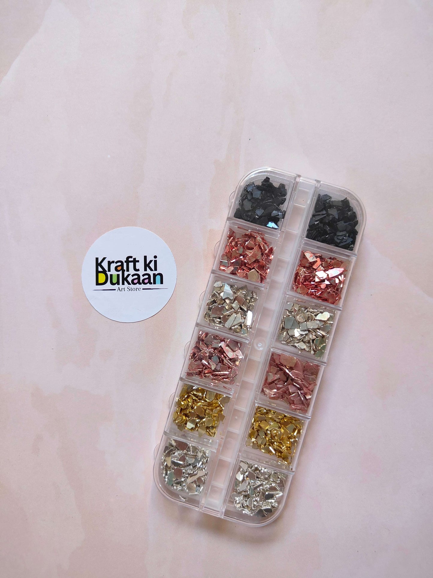 Stone crystal chips box with clear divided compartments, dark, copper, gold, and silver chips
