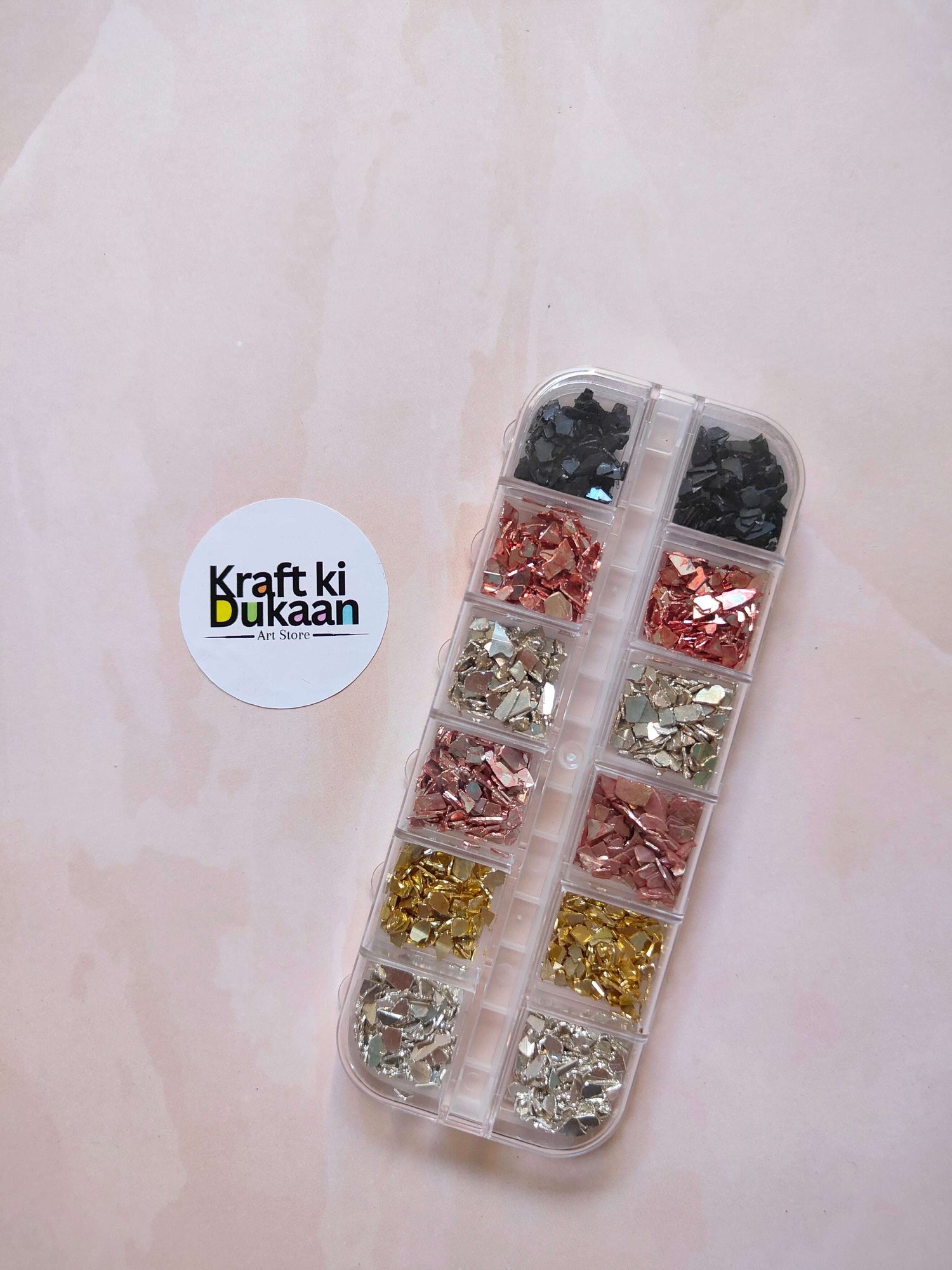 Stone crystal chips box with clear divided compartments, dark, copper, gold, and silver chips