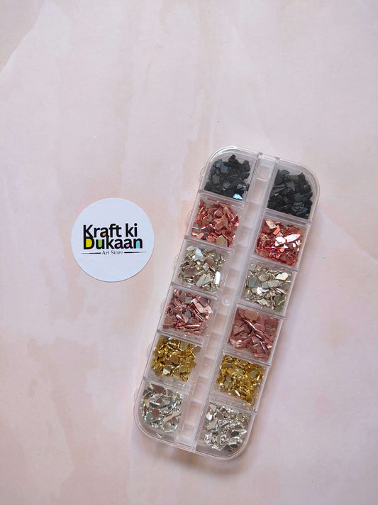 Stone crystal chips box with clear divided compartments, dark, copper, gold, and silver chips