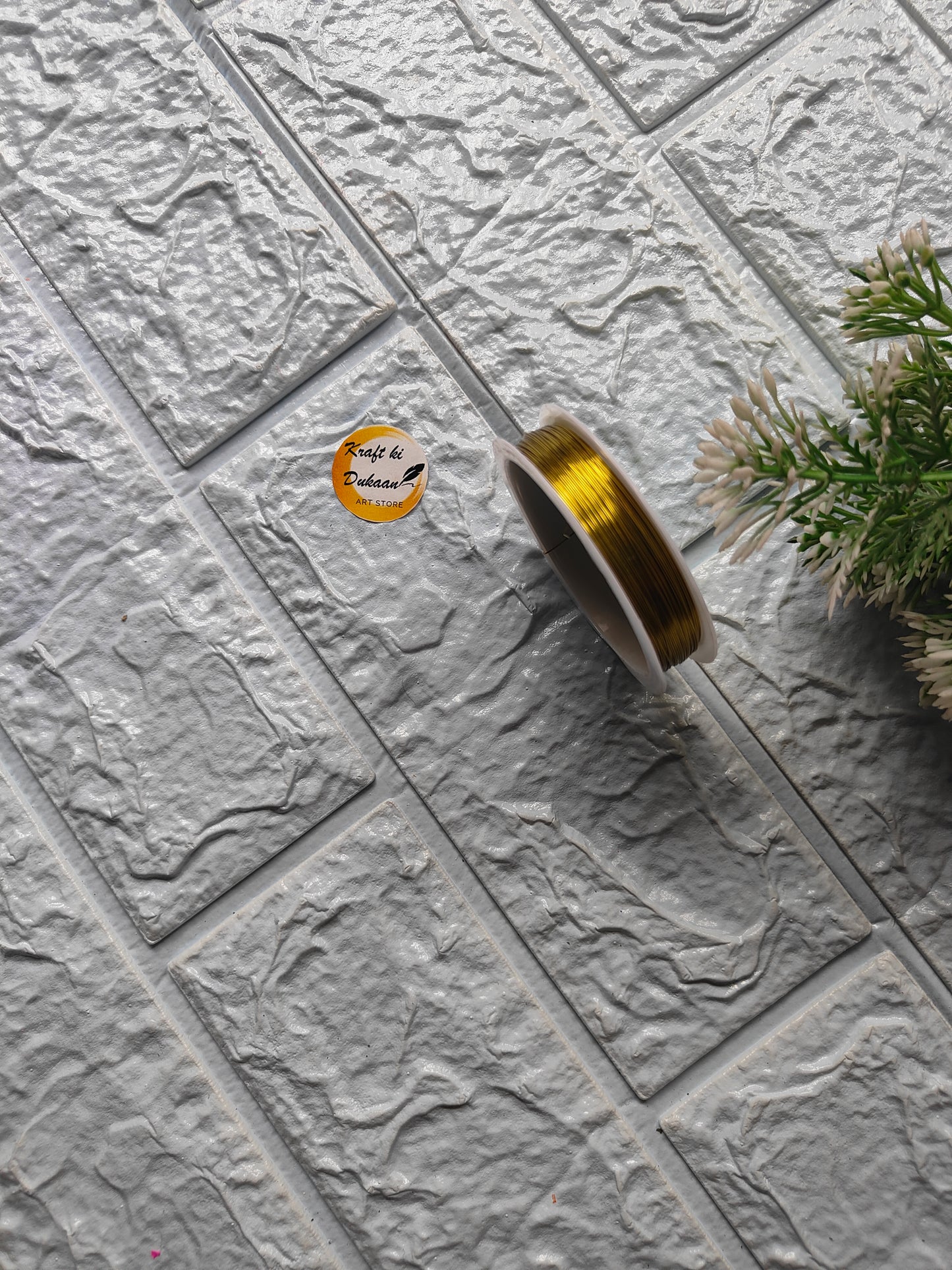 Gold craft wire roll 0.4mm displayed on textured surface for crafting and DIY projects