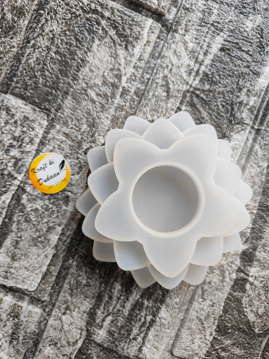 White 3 step T-light mold in flower shape from Kraft ki Dukaan on textured surface