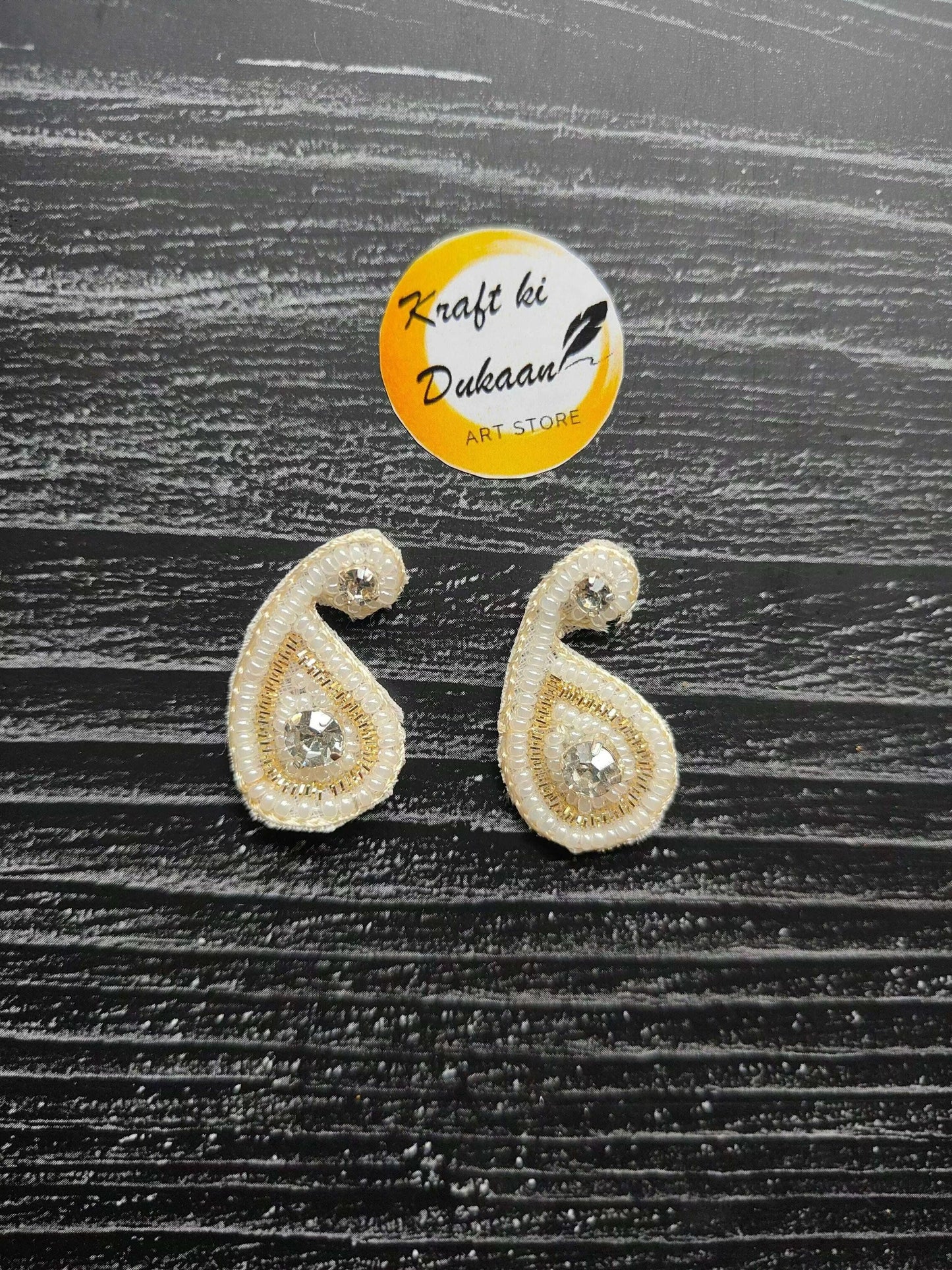 Two small tear-drop rhinestone patches with gold beaded edge and clear center stones