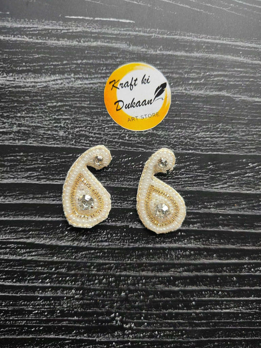Two small tear-drop rhinestone patches with gold beaded edge and clear center stones
