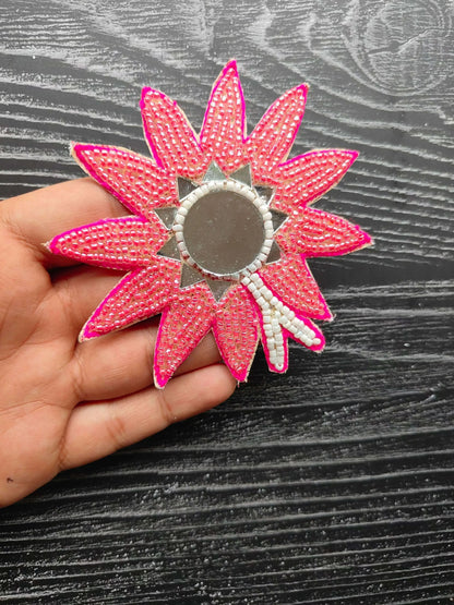 Beaded flower patch with fuchsia pink petals and round gray center.