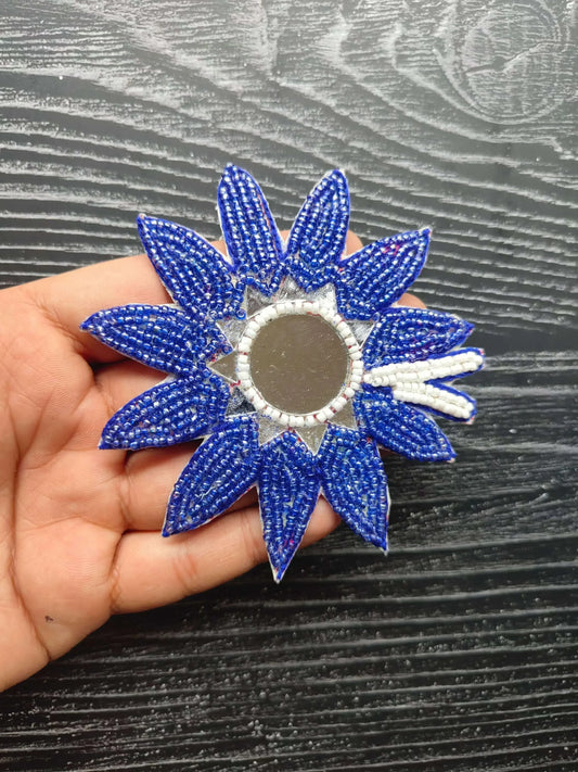 Blue beaded flower patch with round center and white bead edging