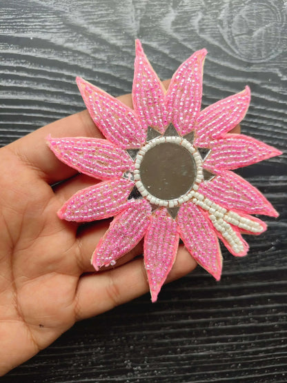 Beaded flower patch with bright pink petals and round gray center.