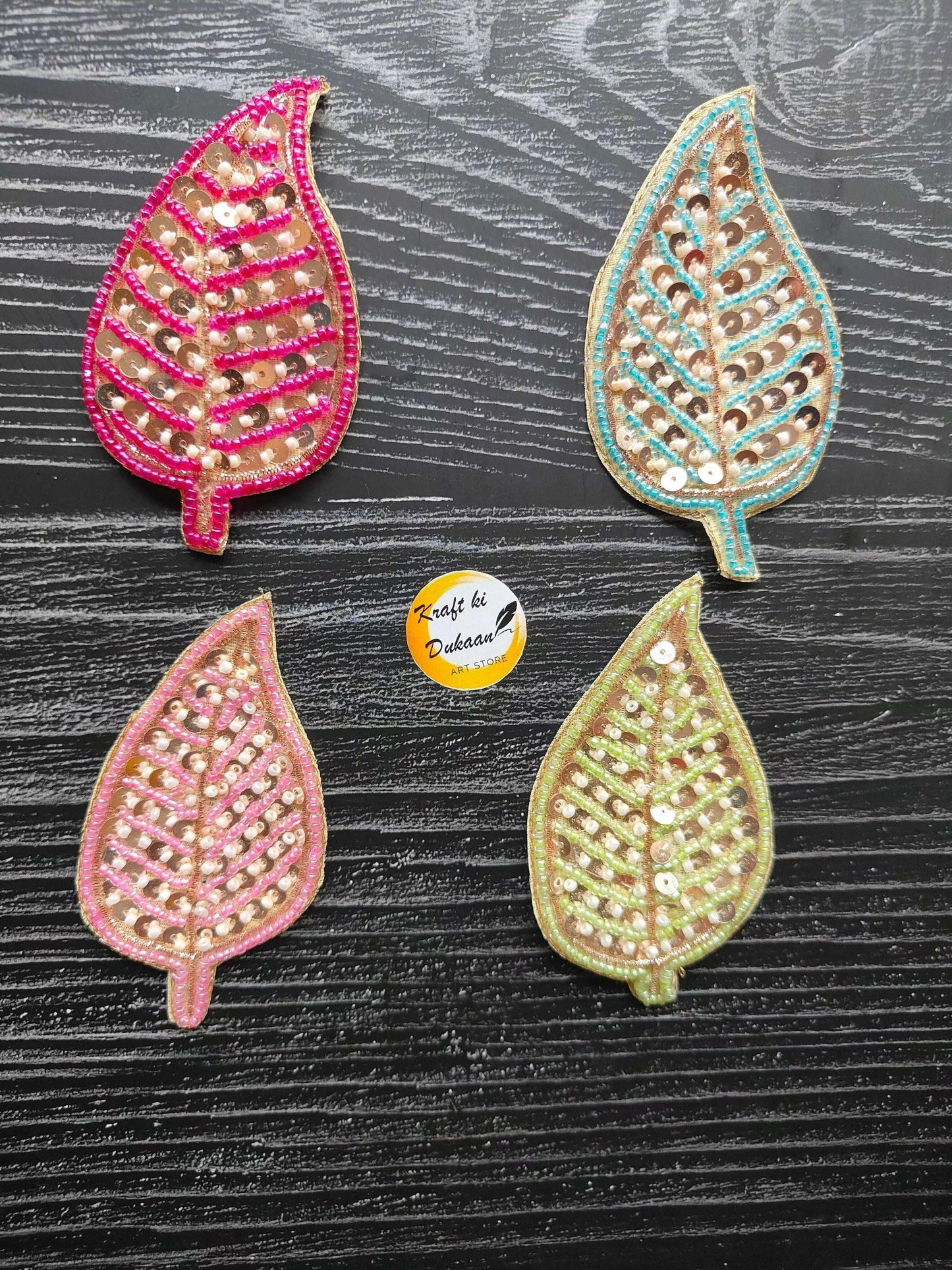 Set of four sequin teardrop decorative patches in pink, teal, and green
