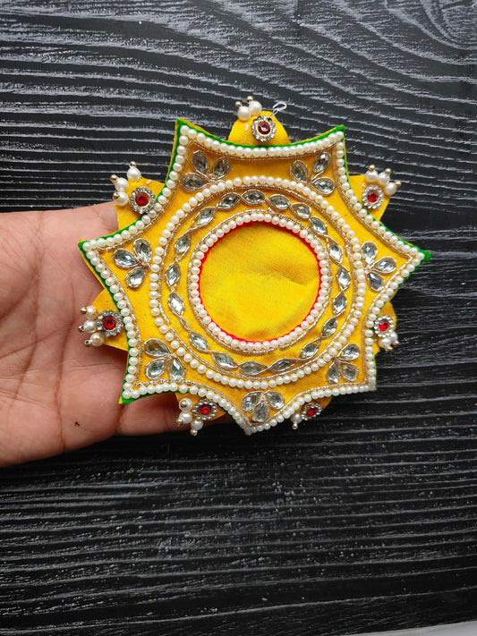Yellow decorative patch with pearl trim and jeweled oval center, star shape