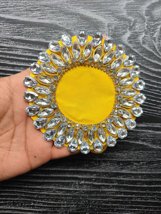 Rundes Strass-Patch mit gelbem Zentrum und silber-goldenem Rand, auf Hand