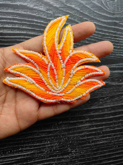 Leaf-shaped decorative patch in orange/yellow with white pearl bead edging