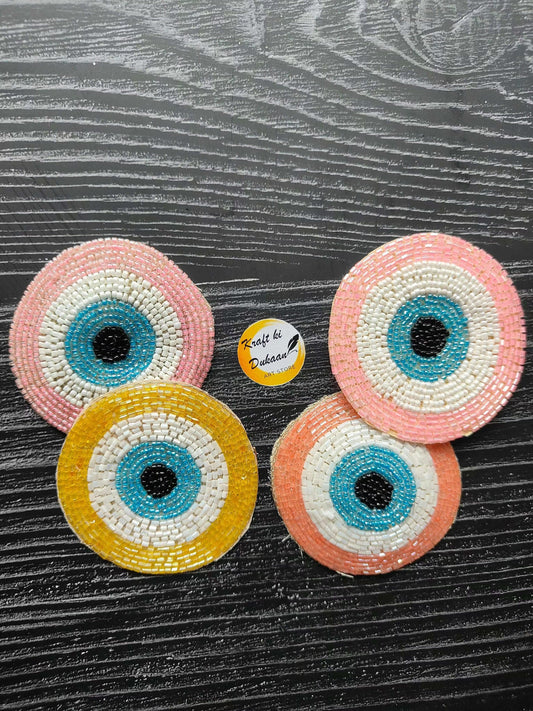 Set of 2 circular beaded eye patches, pink and yellow spiral design
