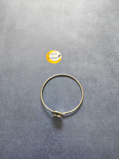 Gold-toned bracelet with small round circular charm