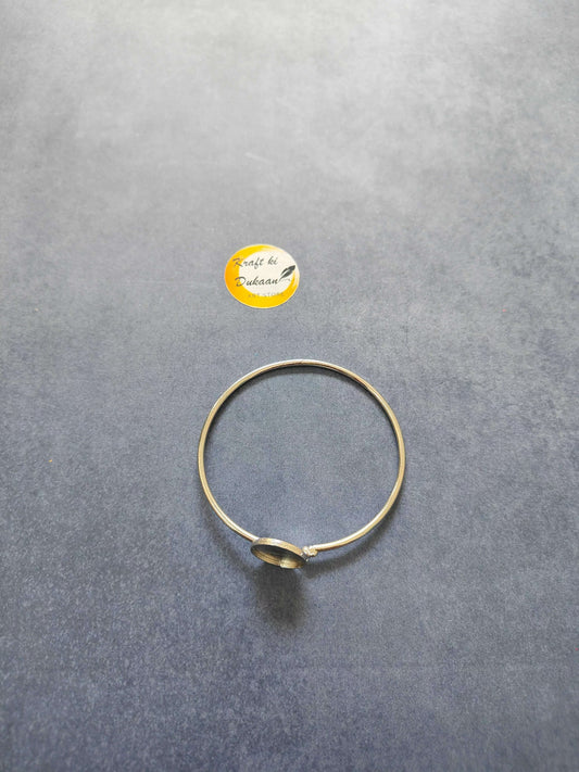 Gold-toned bracelet with small round circular charm