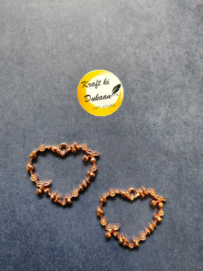 Rose gold heart bezel pendant pair with bezel heart motifs and small dangling charms