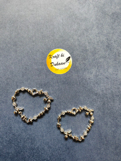 Silver tone heart bezel pendant pair with heart motif and bezel stone accents