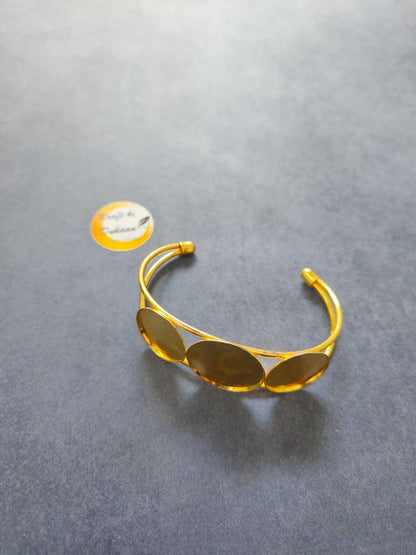 Designer bracelet in Golden with oval amber-toned stones on a slim cuff