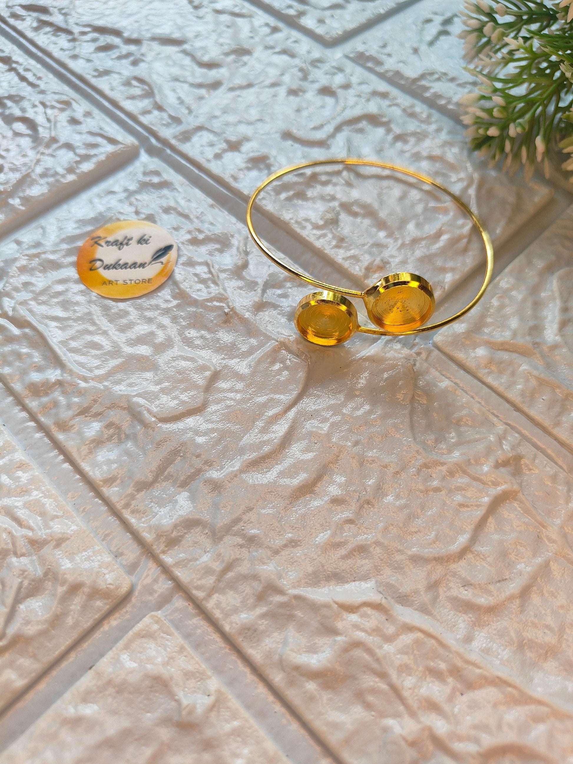 Gold-tone bangle bracelet with two round discs, open wire band