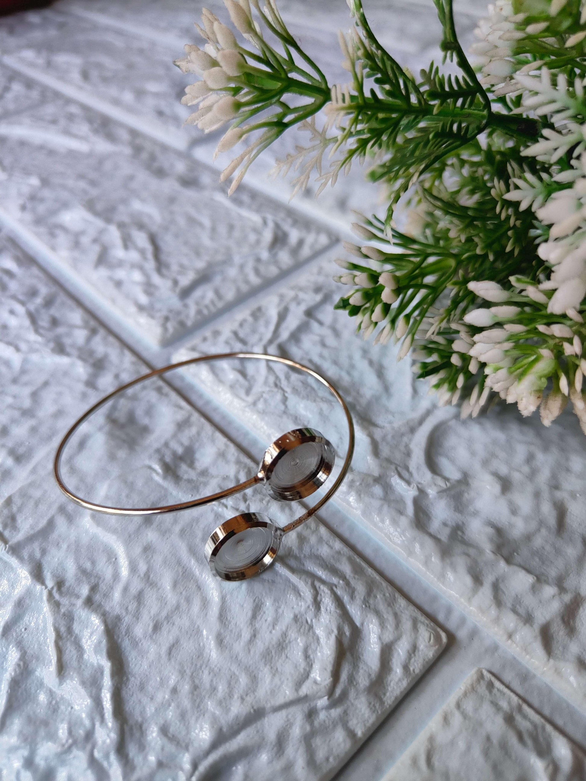 Silver-tone bracelet with two stacked round discs and thin wire bangle