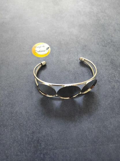 Designer bracelet in Silver with three oval dark stones on a thin cuff