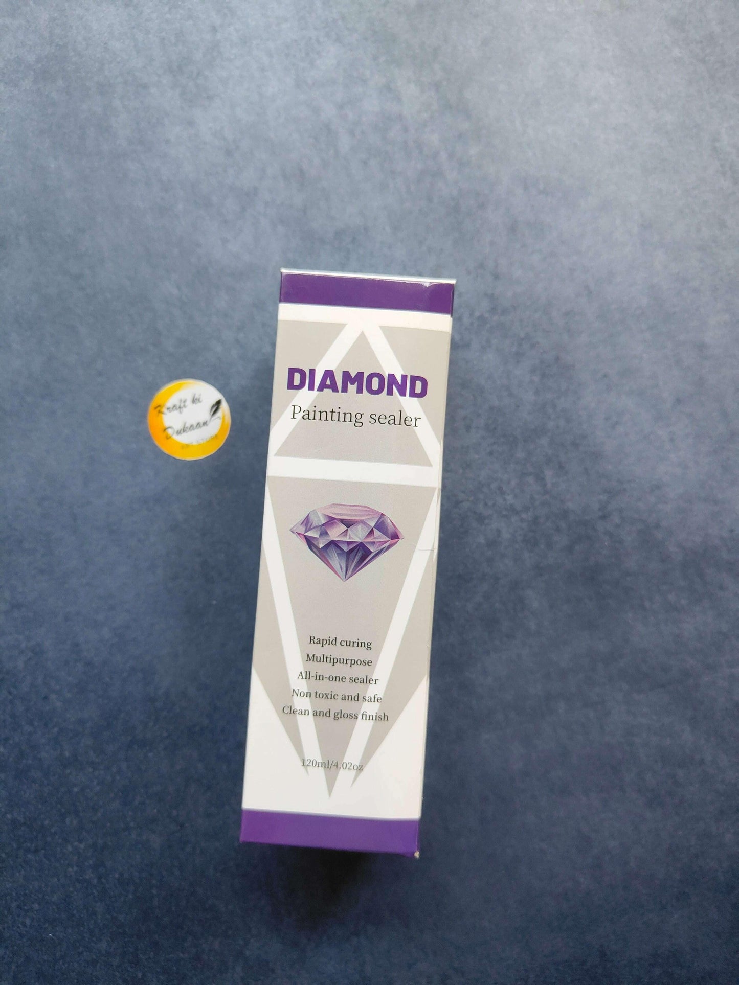 Diamond painting sealer carton with purple label, diamond artwork, and product details