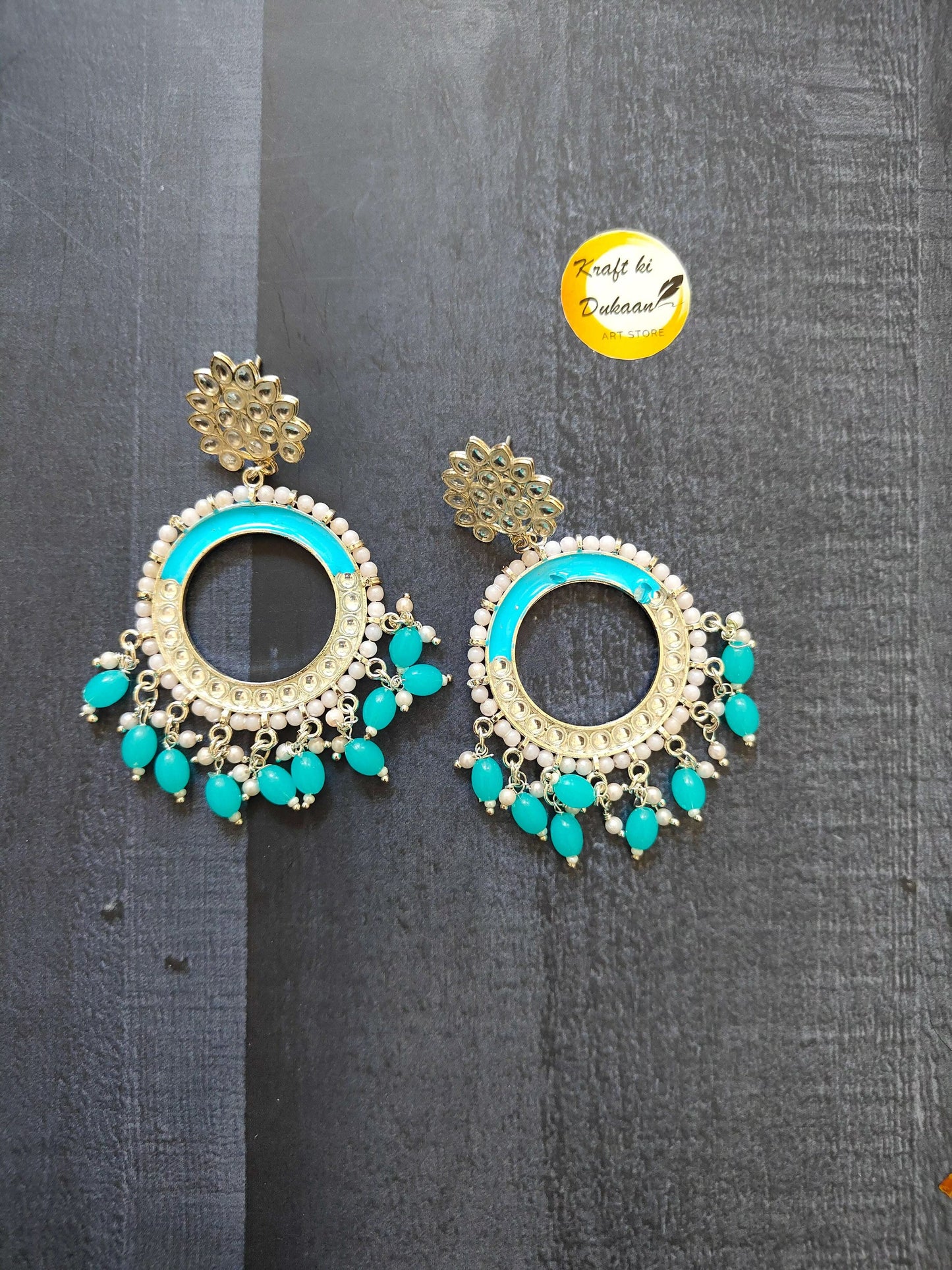Gold-tone chand bali earrings with turquoise center rim and turquoise bead fringe.