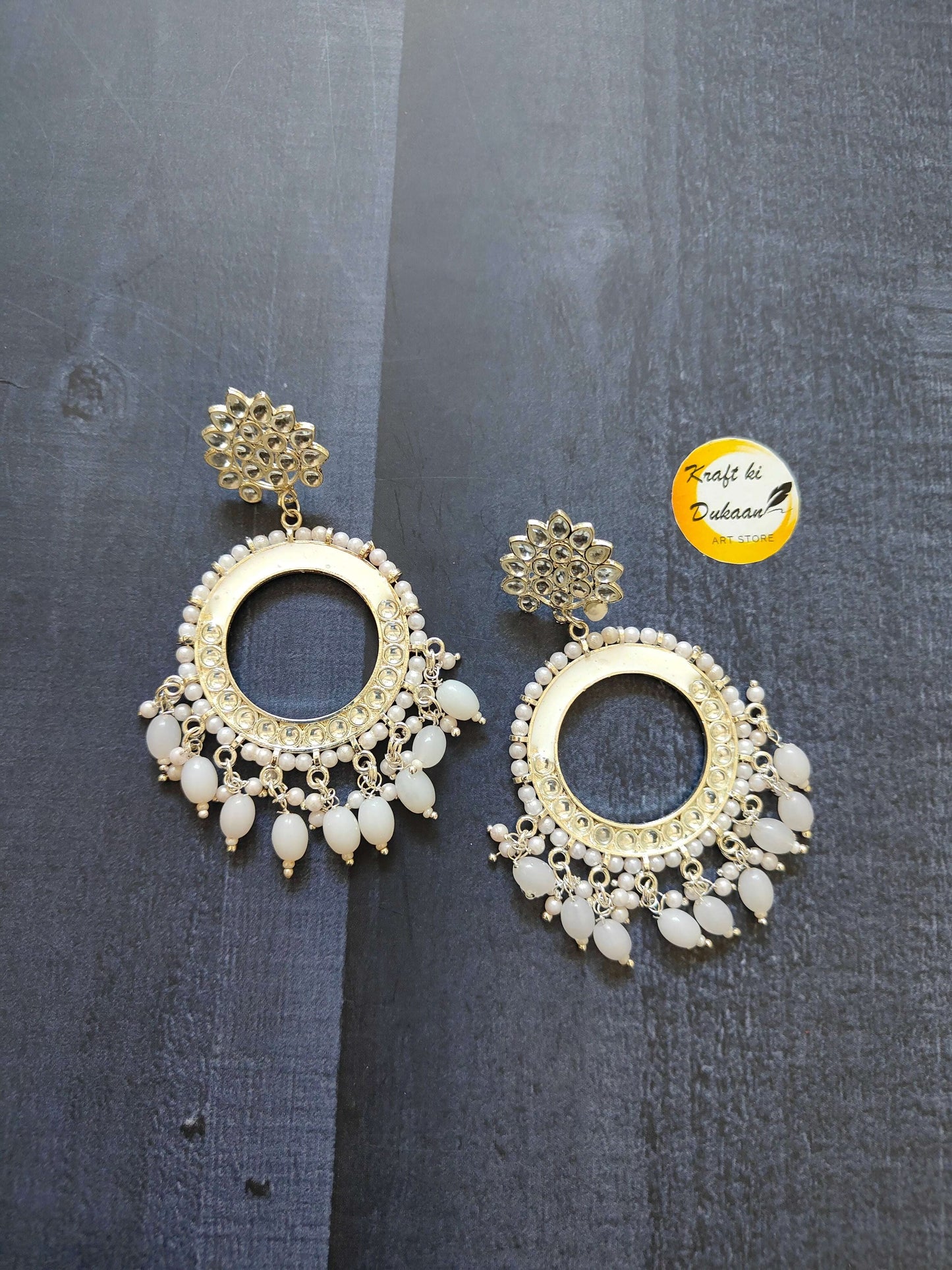 Gold-tone chand bali earrings with white beaded rim and white teardrop fringe.