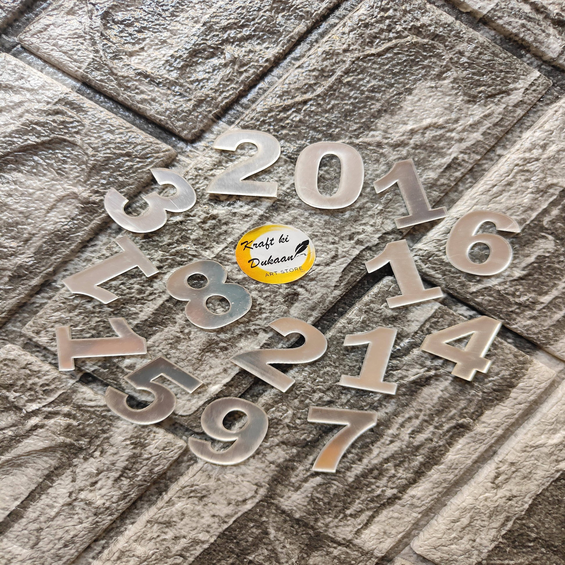 Clear acrylic English number embellishments in various sizes and styles for creative projects
