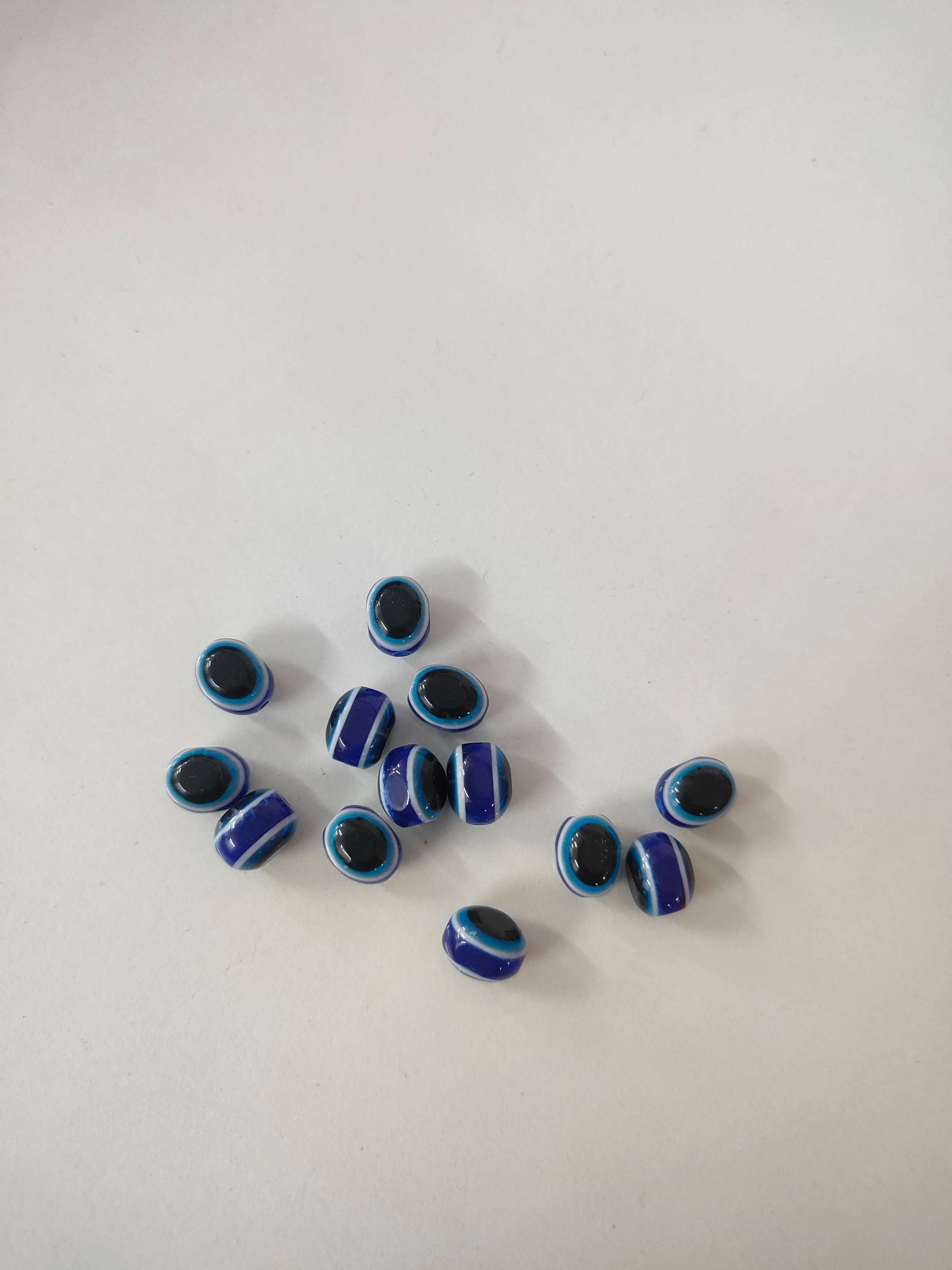 Oval evil eye beads in blue and black tones, assorted set (25 beads)