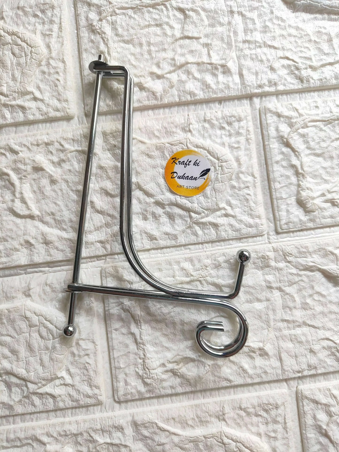 Foldable silver metal stand with curved hooks and base legs
