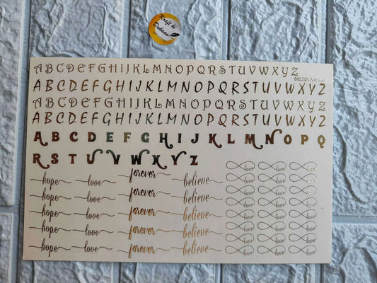 Gold alphabet sticker sheet featuring letters and words like hope, love, and forever for creative projects