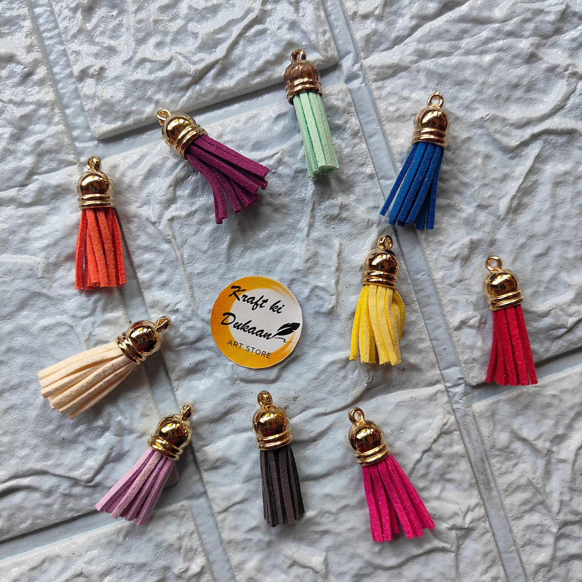 Colorful Gold Leather Tassel Charms in various hues for crafting and DIY projects