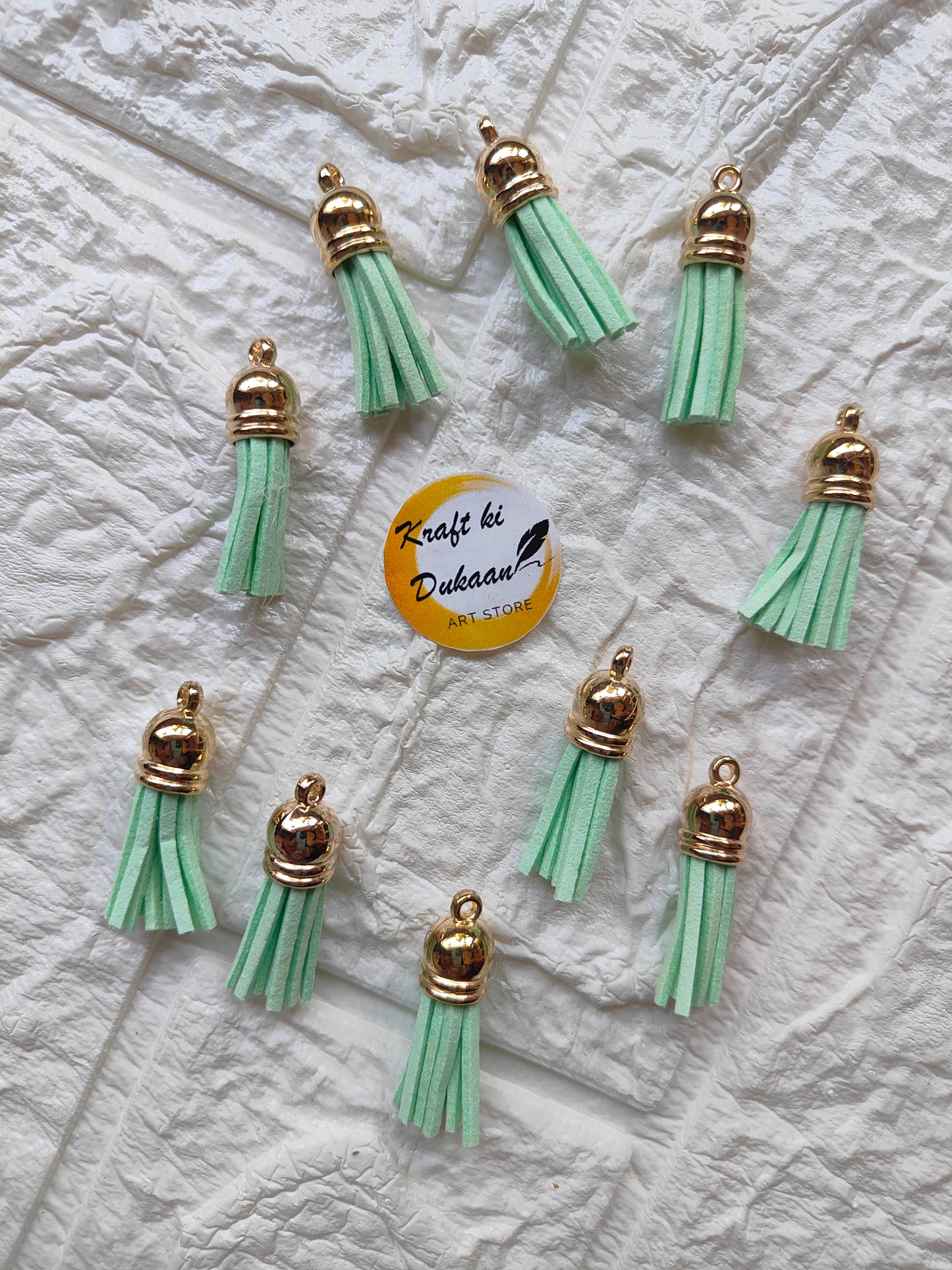 Set of green leather tassels with gold metal caps for DIY projects from Kraft ki Dukaan