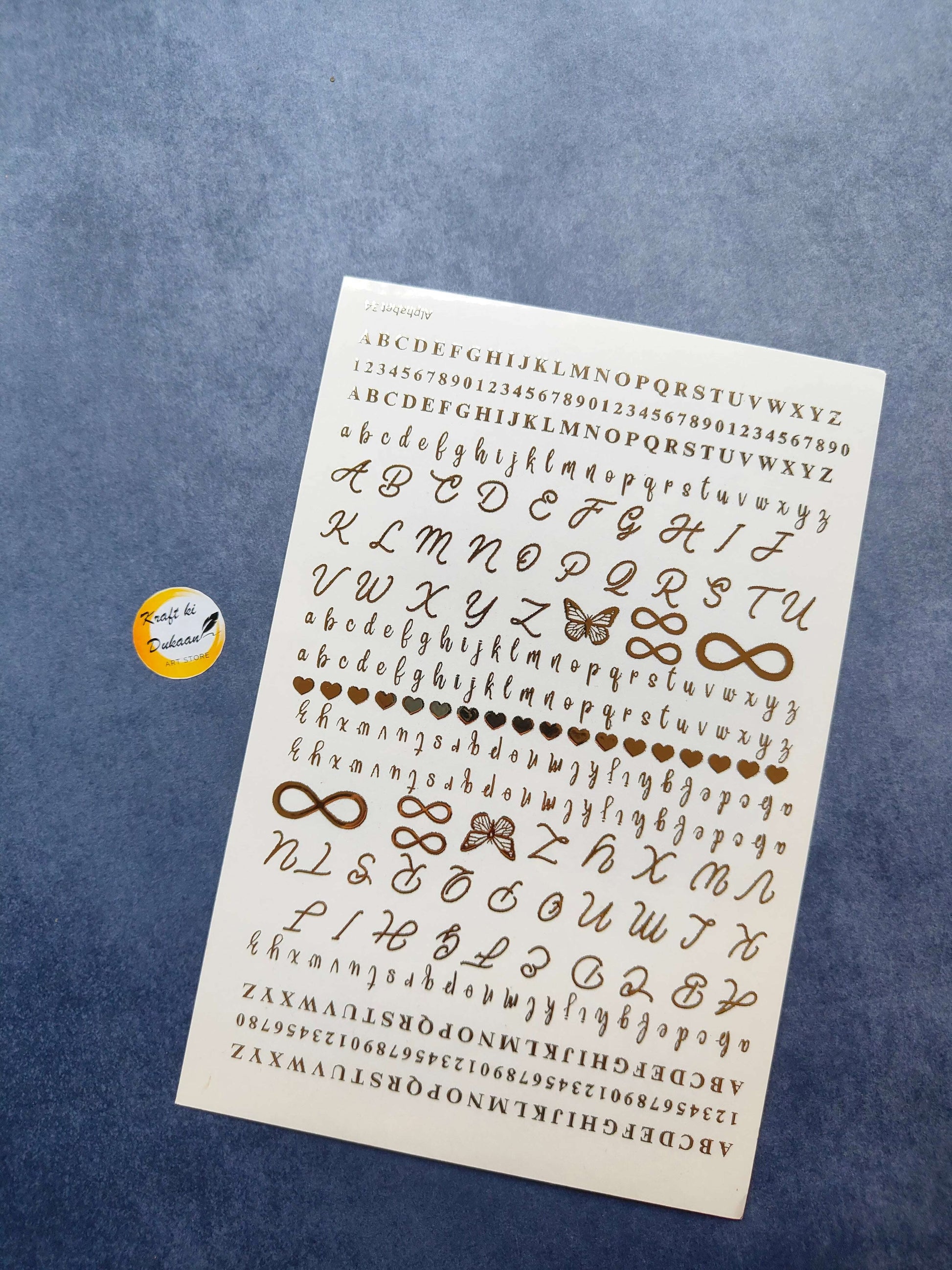 Gold metal sticker sheet for crafts featuring letters, numbers, and decorative symbols