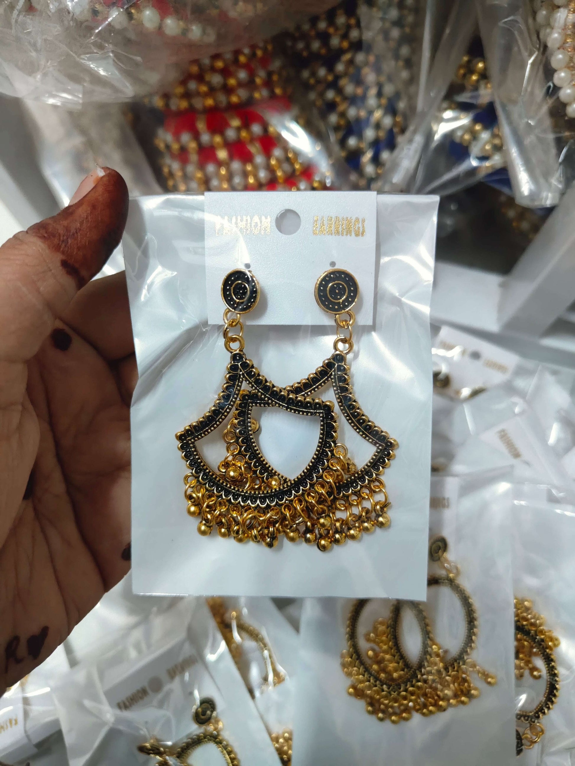 Diya-shaped jhumka earrings, dark blue enamel with gold-toned dangling balls