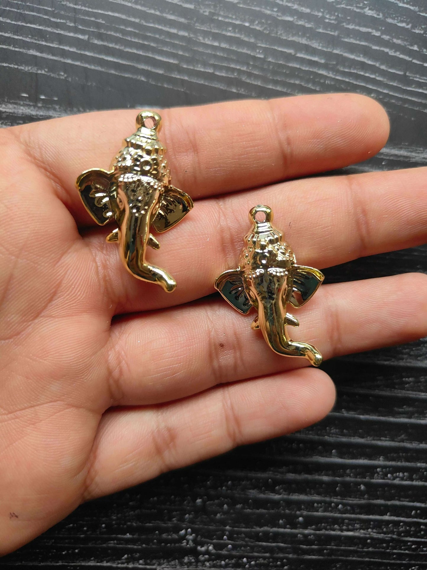 golden-ganpati-face-charms-handheld-angled-view