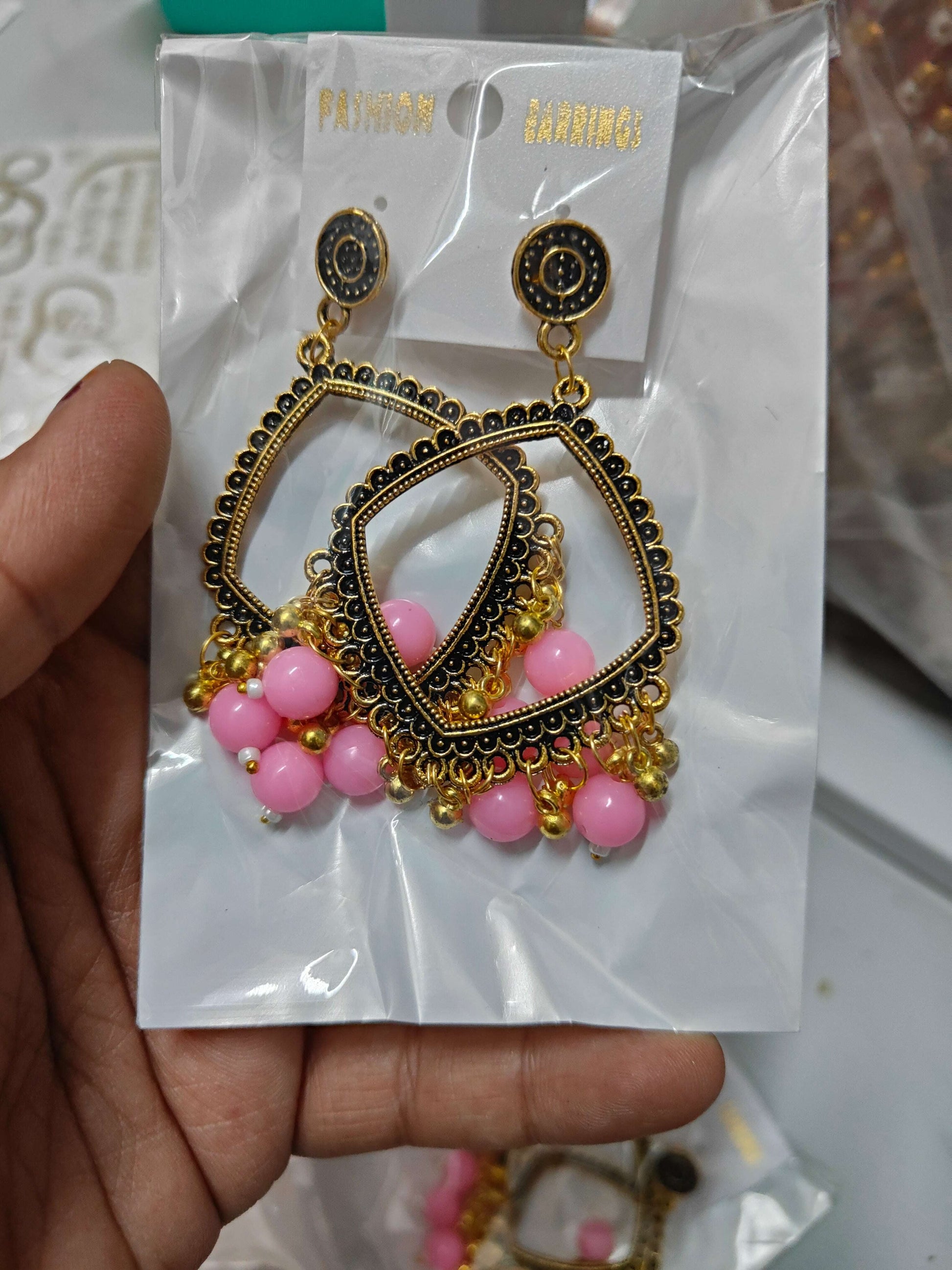 Golden square jhumka with beads, gold and black earrings with pink bead tassel drops