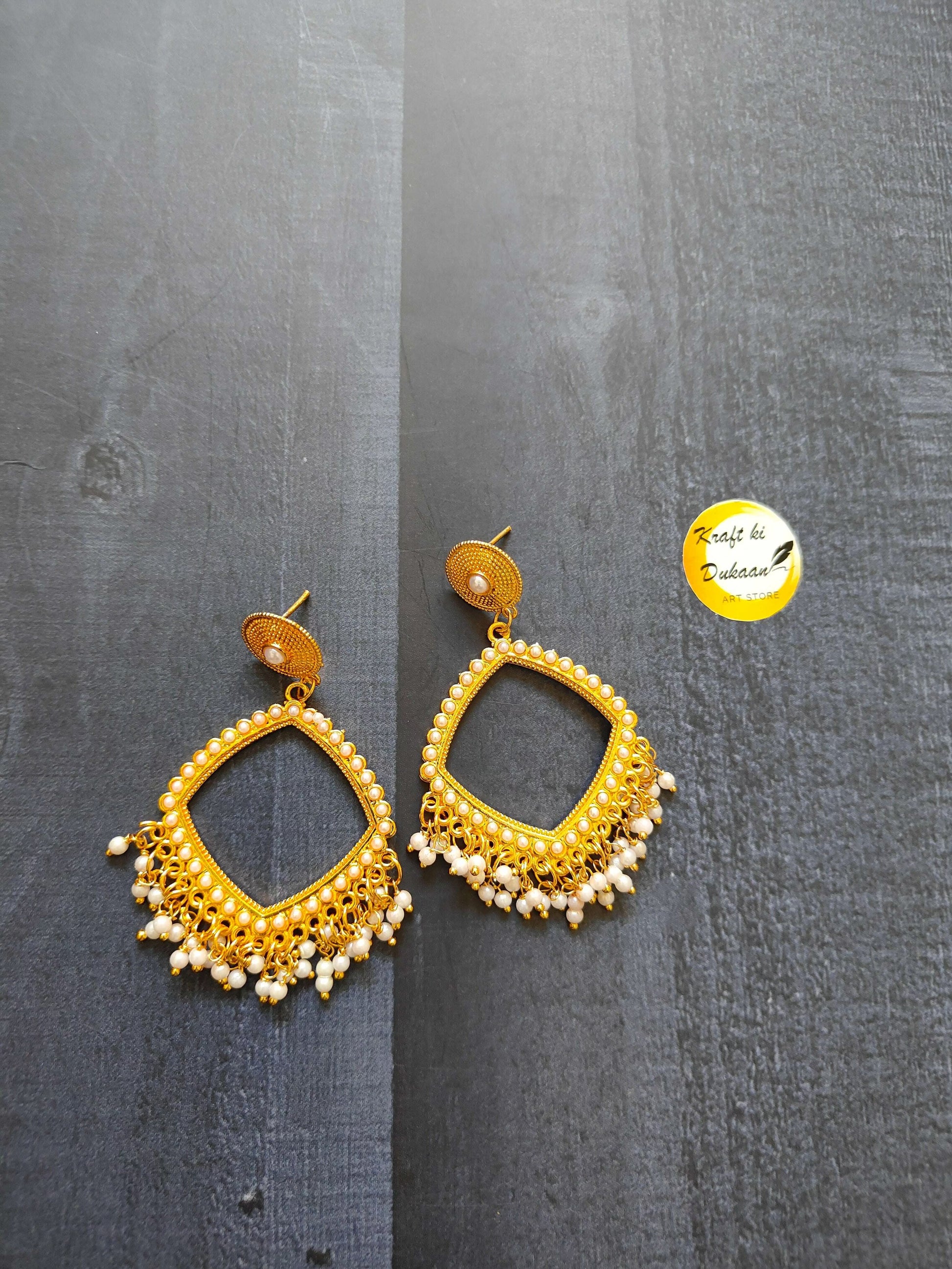 Golden square jhumka earrings with moti bead drops and gold-toned frame