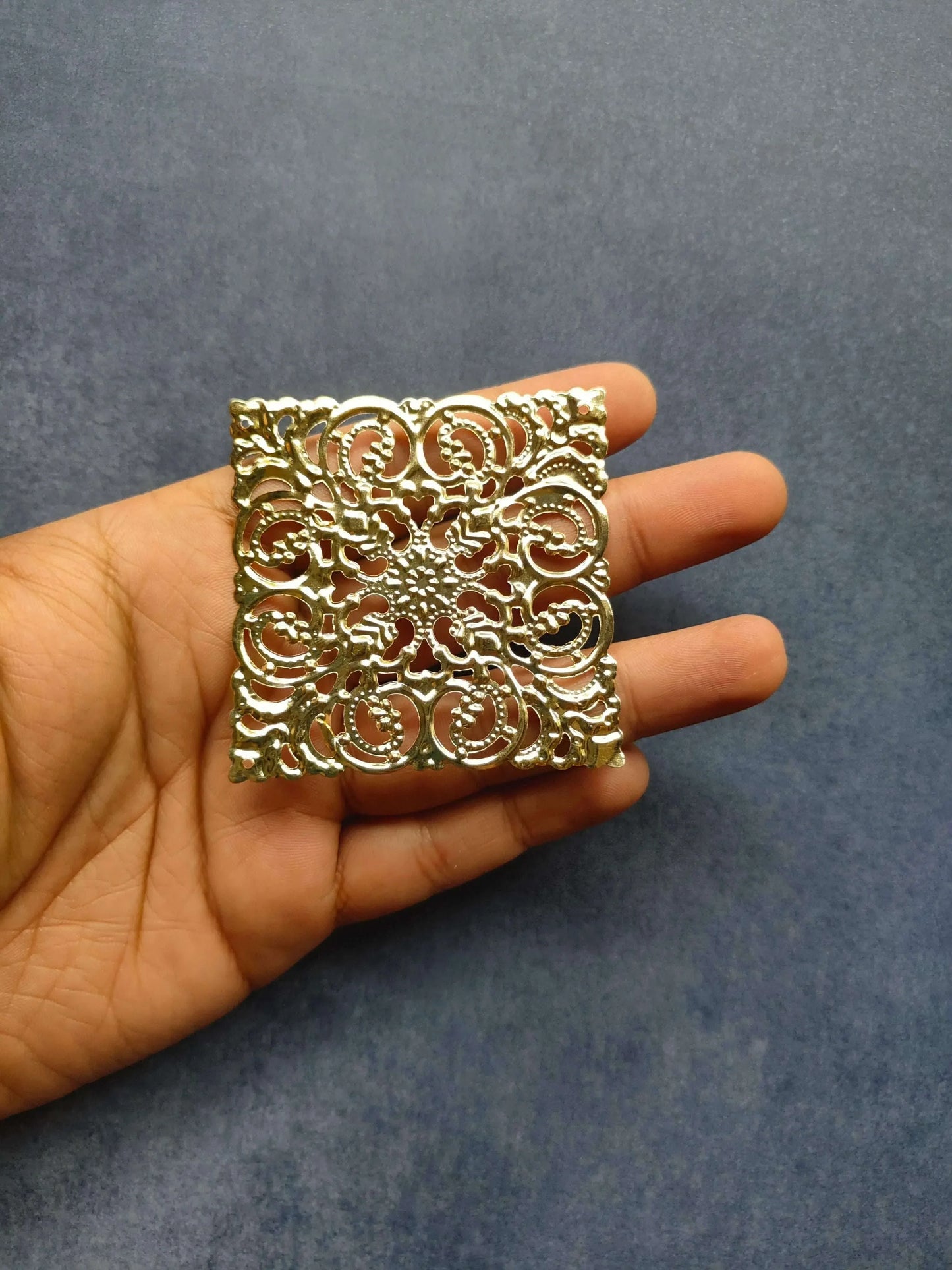 Golden square t-light plate with embossed swirl and heart-like filigree details
