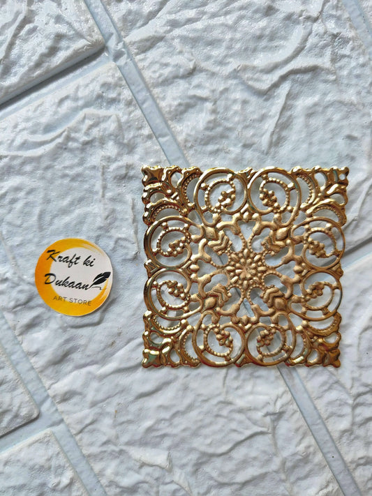 Golden square t-light plate featuring detailed circular filigree embossing