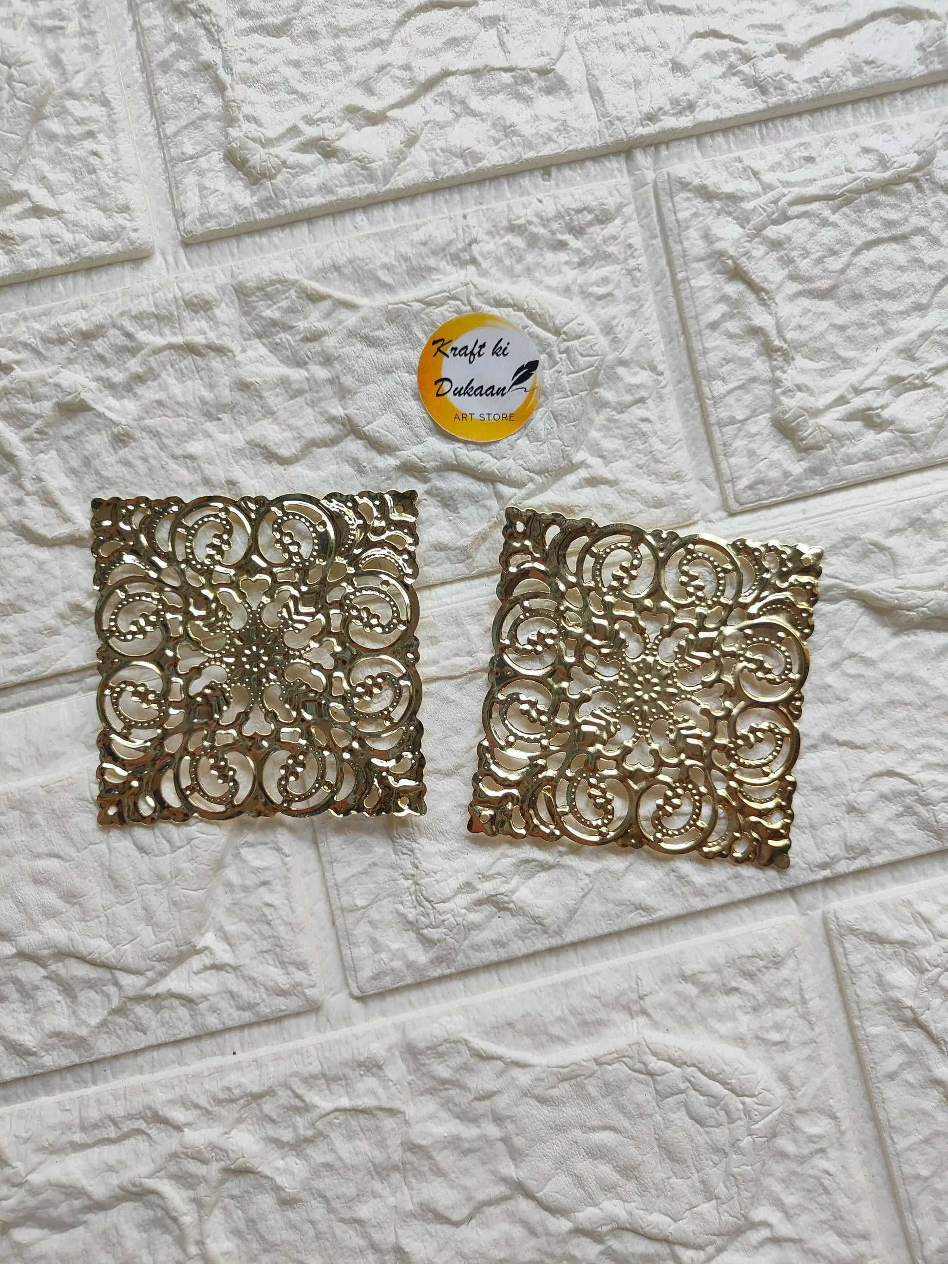 Golden square tea light plate with ornate filigree cutout pattern