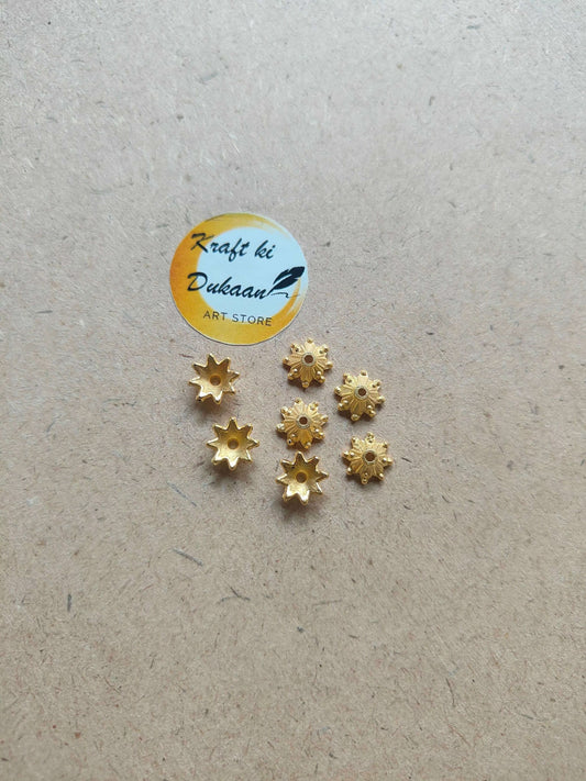 golden-star-flower-beads-for-crafts-six-beads-on-cardboard