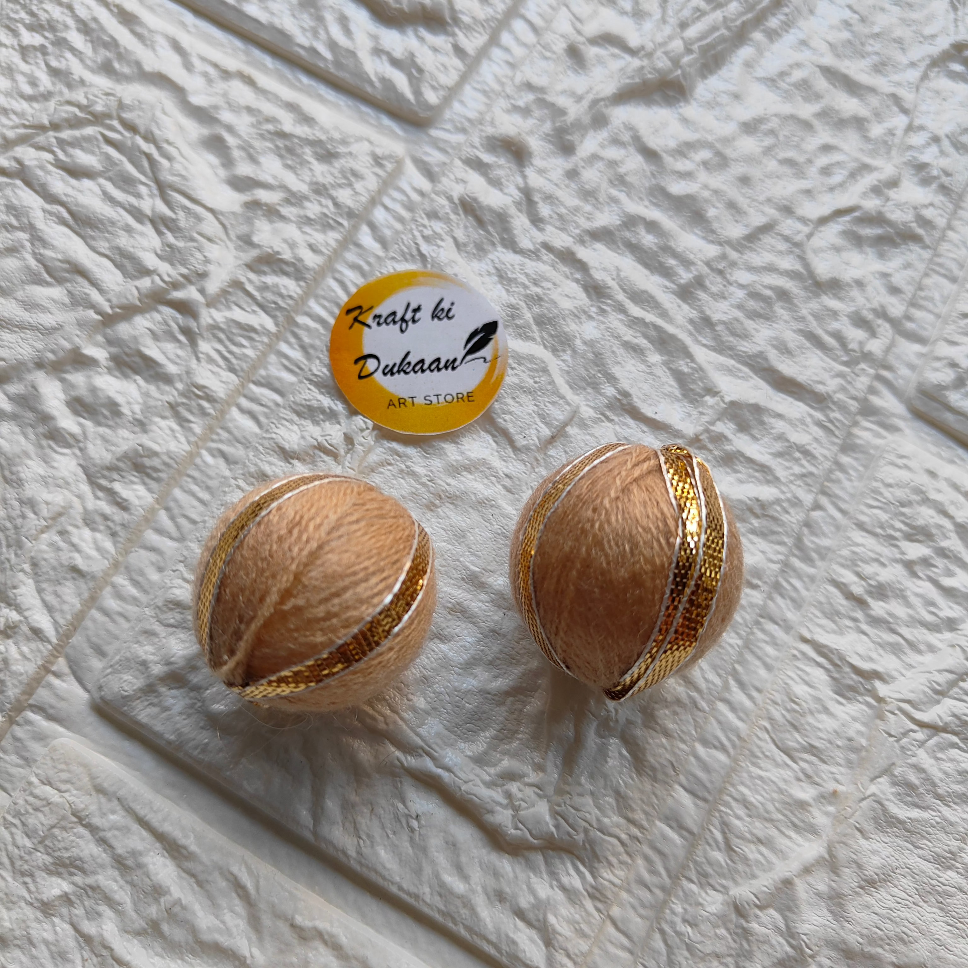 Handmade Gota Patti craft balls in peach with decorative golden accents for crafts and decorations