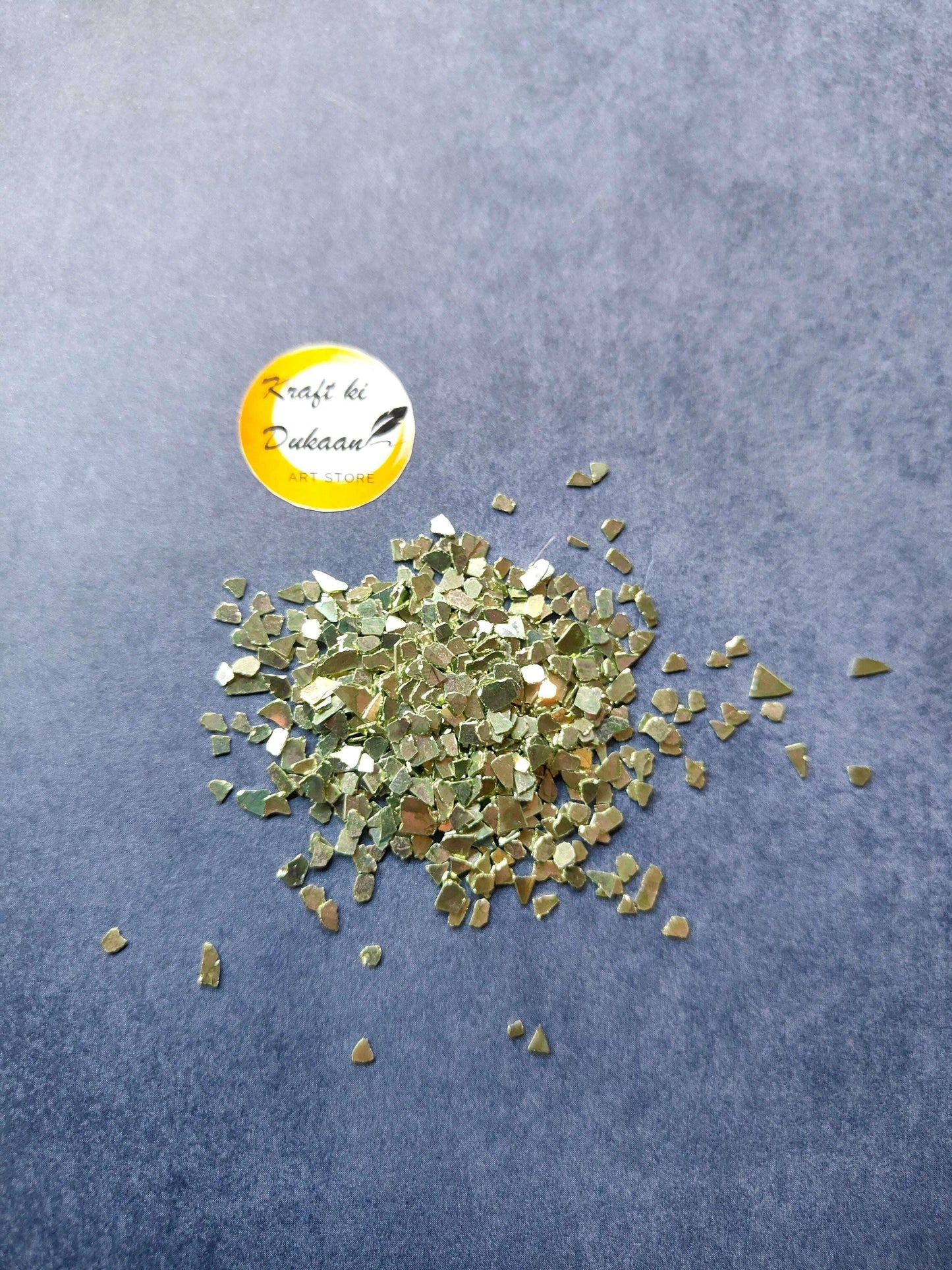 green-crystal-chips-for-resin-art-pile-on-blue-background